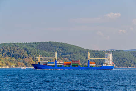 Ship sails Bosphorus on sunny autumn day.の写真素材