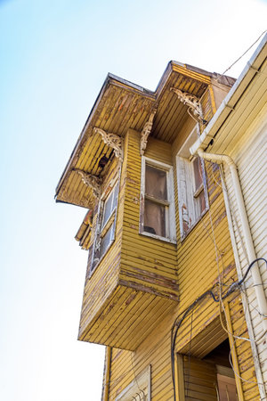 Street with typical old wooden traditional houses and filigree sidewalk in the od part of district Fatih.の写真素材