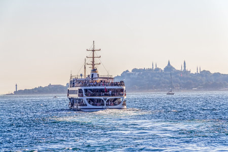 ISTANBUL, TURKEY - SEPTEMBER 29, 2013 Tourist boat floats in front of the Golden Horn with Topkapi...