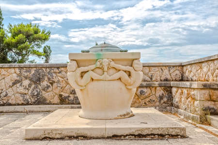 Stone well in addition to the family mausoleum Petranovic at the old cemetery in Supetar.の写真素材