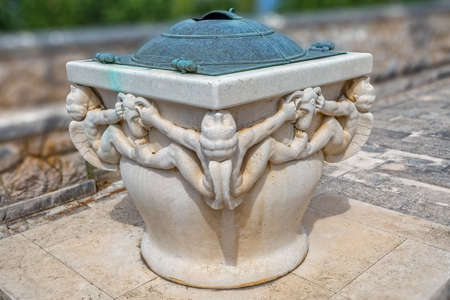 Stone well in addition to the family mausoleum Petranovic at the old cemetery in Supetar.の写真素材
