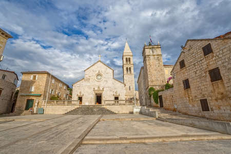 The old church and the clock tower in Supetar town center.の写真素材