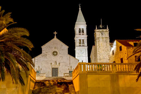 The old church and the clock tower in Supetar town center by the night.の写真素材
