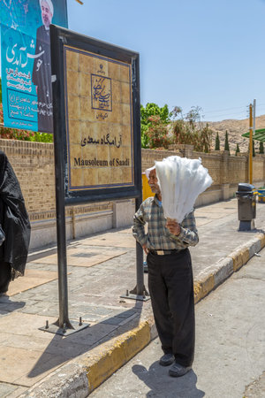 SHIRAZ, IRAN - MAY 2, 2015: A man selling cotton candy infront of the mausoleum of Saadi, known also as the tomb of Sa'dy or Sadiyeh.のeditorial素材