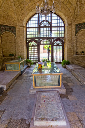 SHIRAZ, IRAN - MAY 2, 2015: The marble graves of famous Iranians in the mausoleum near the tomb of...