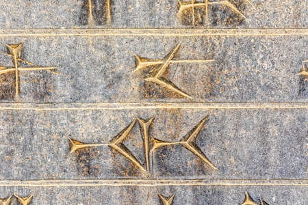 Part of ancient cuneiform closeup detail on the stairway facade of the Apadana at the Persepolis, Iran.の写真素材