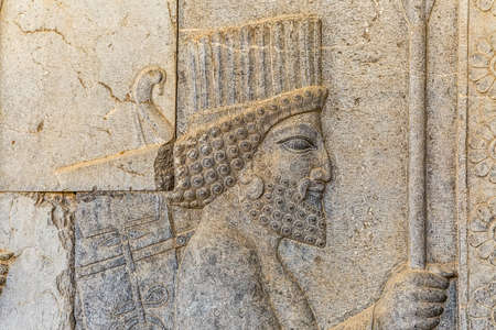 Stone bas-relief of residents of historical empire carved on the stairway facade of the Apadana at the old city Persepolis, capital of the Achaemenid Empire.の写真素材