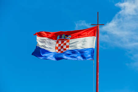 Croatian flag waving in the wind against blue sky.の写真素材