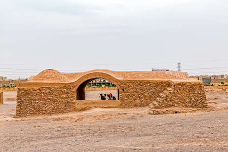 YAZD, IRAN - MAY 4, 2015: Two photografers taking the photos at the disused buildings at the foot of the hills of the Tower of Silence.のeditorial素材