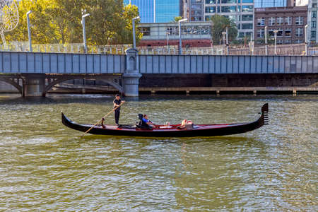 MELBOURNE, AUSTRALIA - MARCH 21, 2015: A romantic ride in a gondola with the gondolier, on Yarra River at autumn season.のeditorial素材