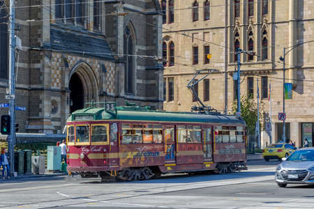 MELBOURNE, AUSTRALIA - MARCH 21, 2015: The historic and informative City Circle Tram popular with tourists travels passes by the St. Paul Cathedral.のeditorial素材