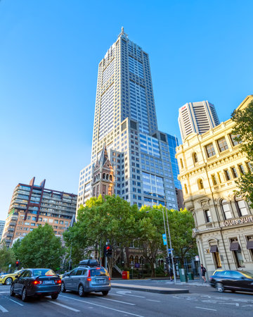 MELBOURNE, AUSTRALIA - MARCH 21, 2015: St Michael's Uniting Church tower with modern building,...