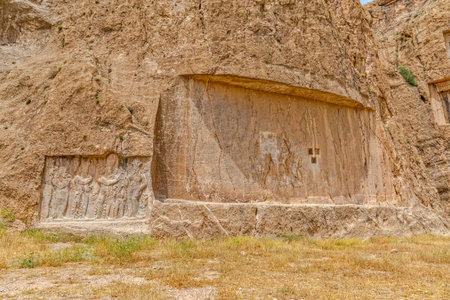 Ancient relief of the necropolis Naqsh-e Rustam that shows the ordination of Narseh by goddess Anahita, Iran, Sasanian civilization 4th century AD.の写真素材