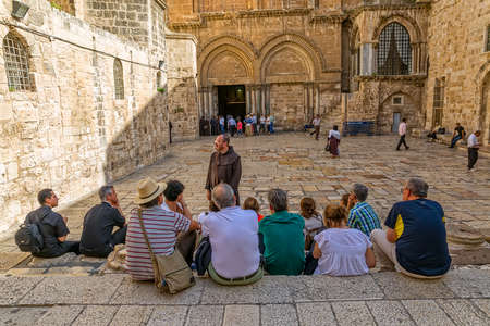 JERUSALEM, ISRAEL - JUNE 19, 2015: Monk and pilgrims at the atrium of the Church of the Holy Sepulchre, holiest Christian site in the world.のeditorial素材