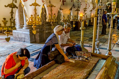 JERUSALEM, ISRAEL - JUNE 19, 2015: People make pilgrimages to the Stone of Anointing in Church of the Holy Sepulchre.のeditorial素材