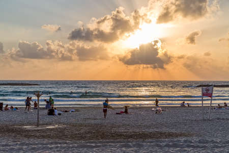 TEL AVIV, ISRAEL - JUNE 19, 2015: People enjoying beautiful sunset on the beach.のeditorial素材