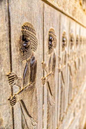 Guardians also known as the Immortals holding a spear, relief detail on the stairway facade of the Apadana at the old city Persepolis.の写真素材