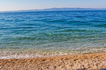 Beautiful sunshine on the clear blue sea, Tucepi town beach in Croatia Europe.