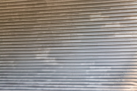 Metal panel made of rounded steel pipes.