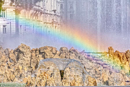 A reflection of the rainbow on the fountainの写真素材