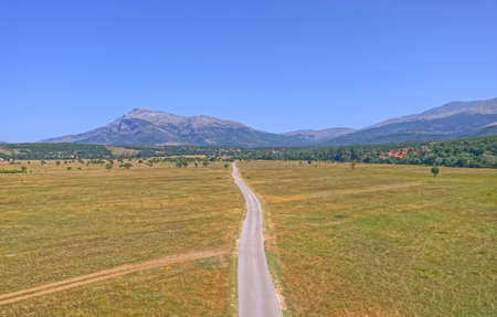 Drone view of the road at the bottom of Dinara Mountain. A beautiful landscape near Sinj, Croatia.の写真素材