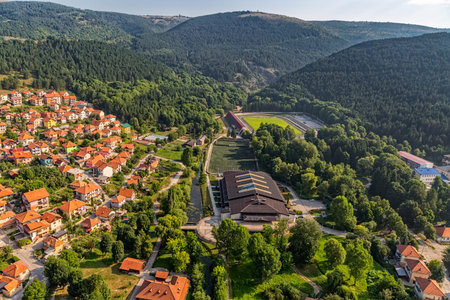 Helicopter aerial view of the sports facilities and residential part of the city Pljevlja on sunny summer day.の写真素材