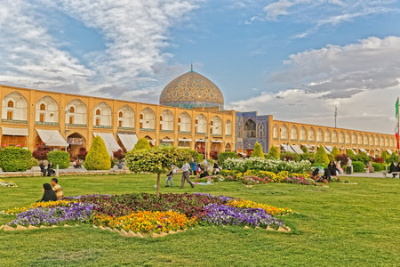 ISFAHAN, IRAN - MAY 9, 2015: People enjoying and relaxing in the sunset on the Imam Square near...