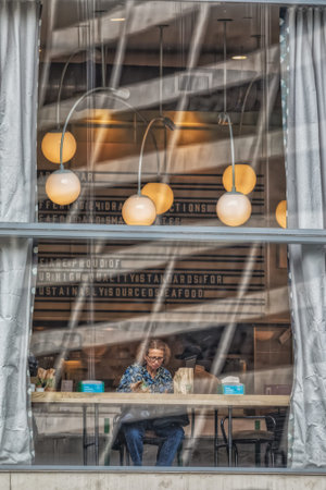People eat at Whole Foods Market restaurant opposite the Bryant Park, New York