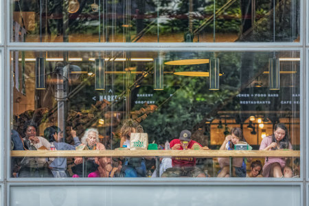 People eat at Whole Foods Market restaurant opposite the Bryant Park, New York