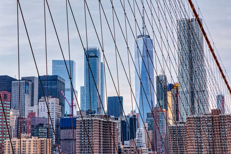 Manhattan through the Brooklyn Bridge cables in New Yorkのeditorial素材