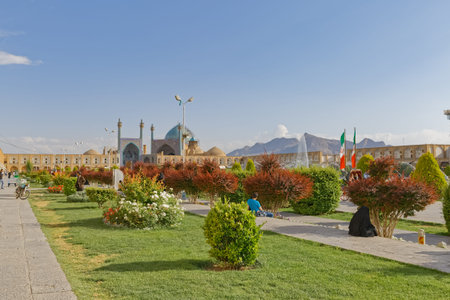 ISFAHAN, IRAN - MAY 9, 2015: People socializing on the Imam Square in front of the Shah mosque.