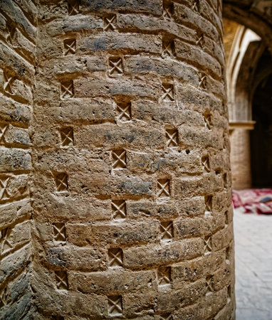 ISFAHAN, IRAN - MAY 8, 2015: Detail of the brick column in old chamber of the Taj al Molk Jameh...