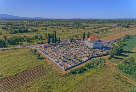 Church and fenced cemetery in the hinterland of Dalmatian Zagoraの写真素材