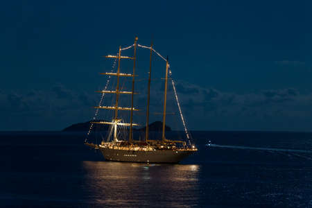 Night scene of a moonlight on the sea and the yacht anchored infront of Dubrovnik, Croatia.の写真素材