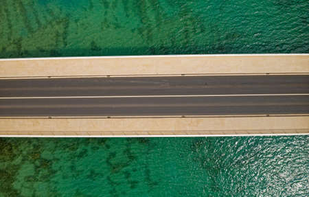 Aerial top view of a long bridge above a seaの写真素材