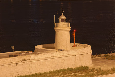 Stone lighthouse by night in Bari Italyの写真素材