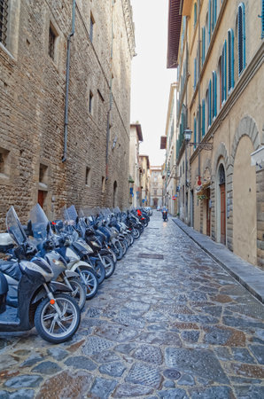 Parked motorcycles in narrow street in Florence Italyのeditorial素材