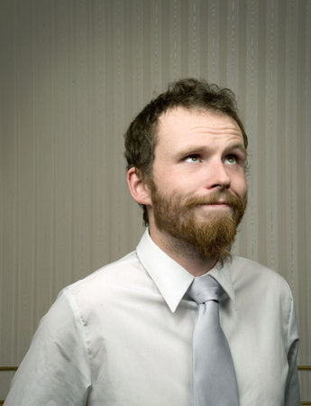young business man looks up to the sky