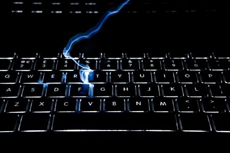 Keyboard with full alphabet backlit has lightning striking the keysの写真素材