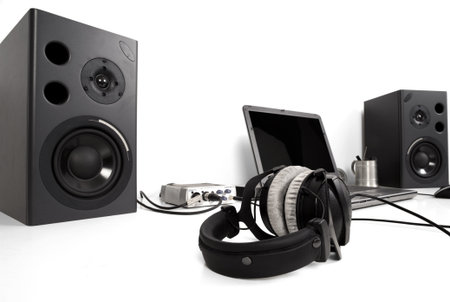 laptop amd speakers with headphones on a desk