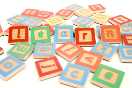 Letters scattered on white background with learn spelled outの写真素材