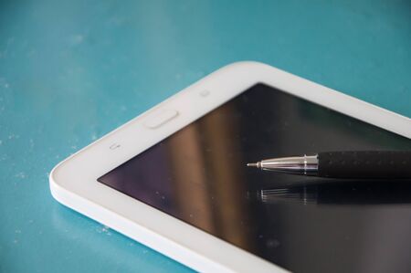 pen with smartphone on blue backgroundの写真素材