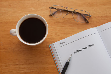 coffee pen with glasses and notebook on table work from home concept