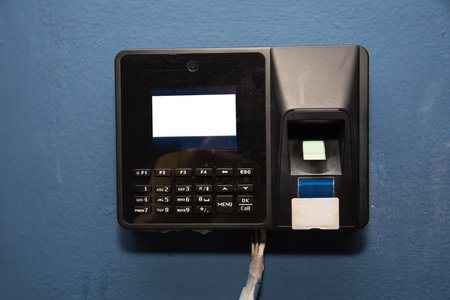 Finger scanner on the blue wall in the building
