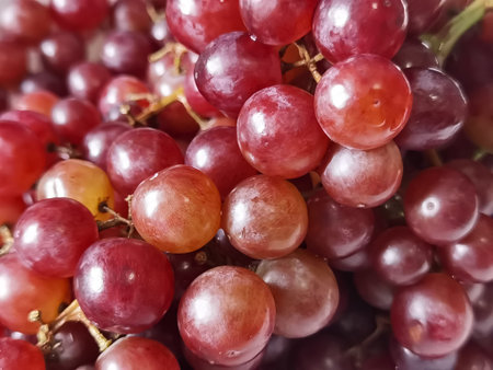 fresh red grapes on a white plate