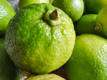 a pile of fresh lemons on the tableの写真素材