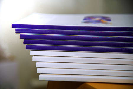 pile of annual report books on the tableの写真素材