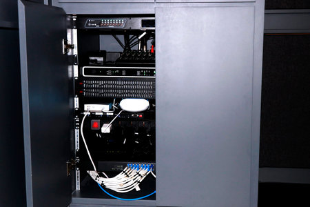 <p>Fiber Optic cables connected to a power supply cabinet in a data center</p>
