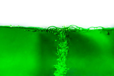 green soda drink with bubbles isolated on white background. close up.