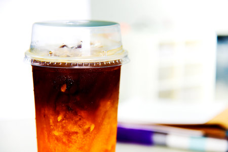 Iced americano coffee in plastic cup on table, stock photoの写真素材
